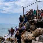 Ceuta migrant crisis showing migrants gathered near the Spain–Morocco border crossing