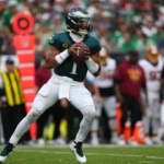 Commanders vs Eagles Jalen Hurts throwing a touchdown pass in Week 1