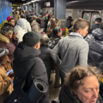 Crowded subway platform at Manhattan's 86th Street-Lexington Avenue station during elevator construction