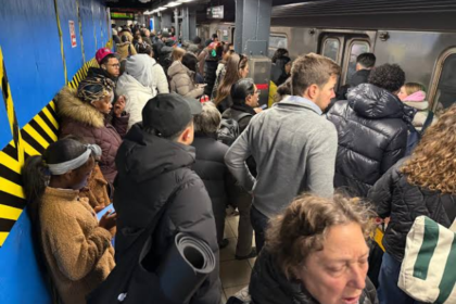 Crowded subway platform at Manhattan's 86th Street-Lexington Avenue station during elevator construction