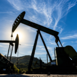 Oil storage tanks and industrial energy infrastructure representing global oil market volatility