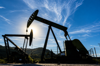 Oil storage tanks and industrial energy infrastructure representing global oil market volatility