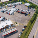 US truck parking crisis with semi-trucks at a crowded highway rest area